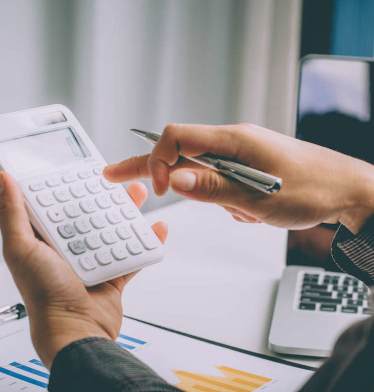 03. Woman calculating costs on a calculator
