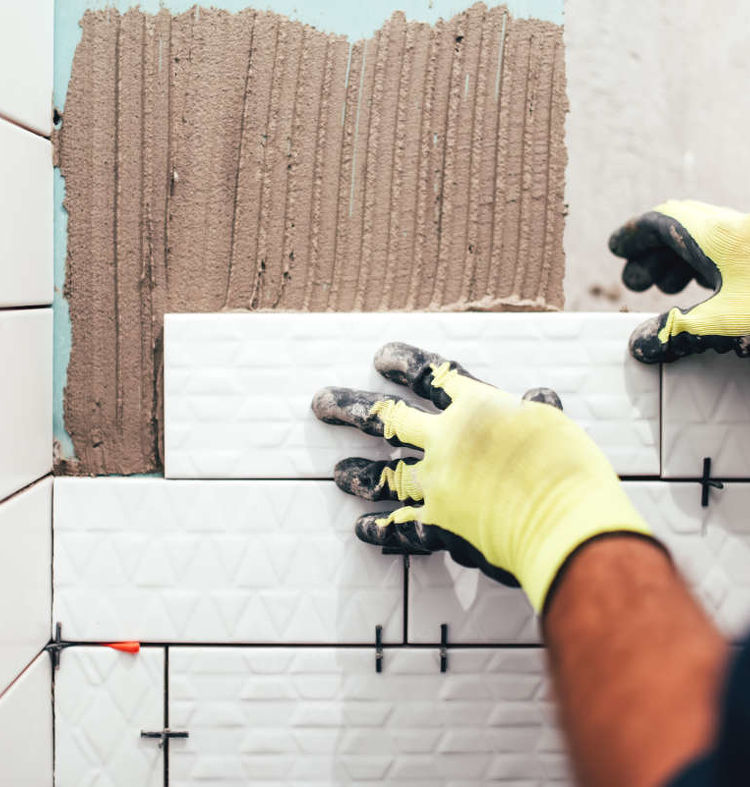 07. Person Renovating and Tiling Bathroom Wall